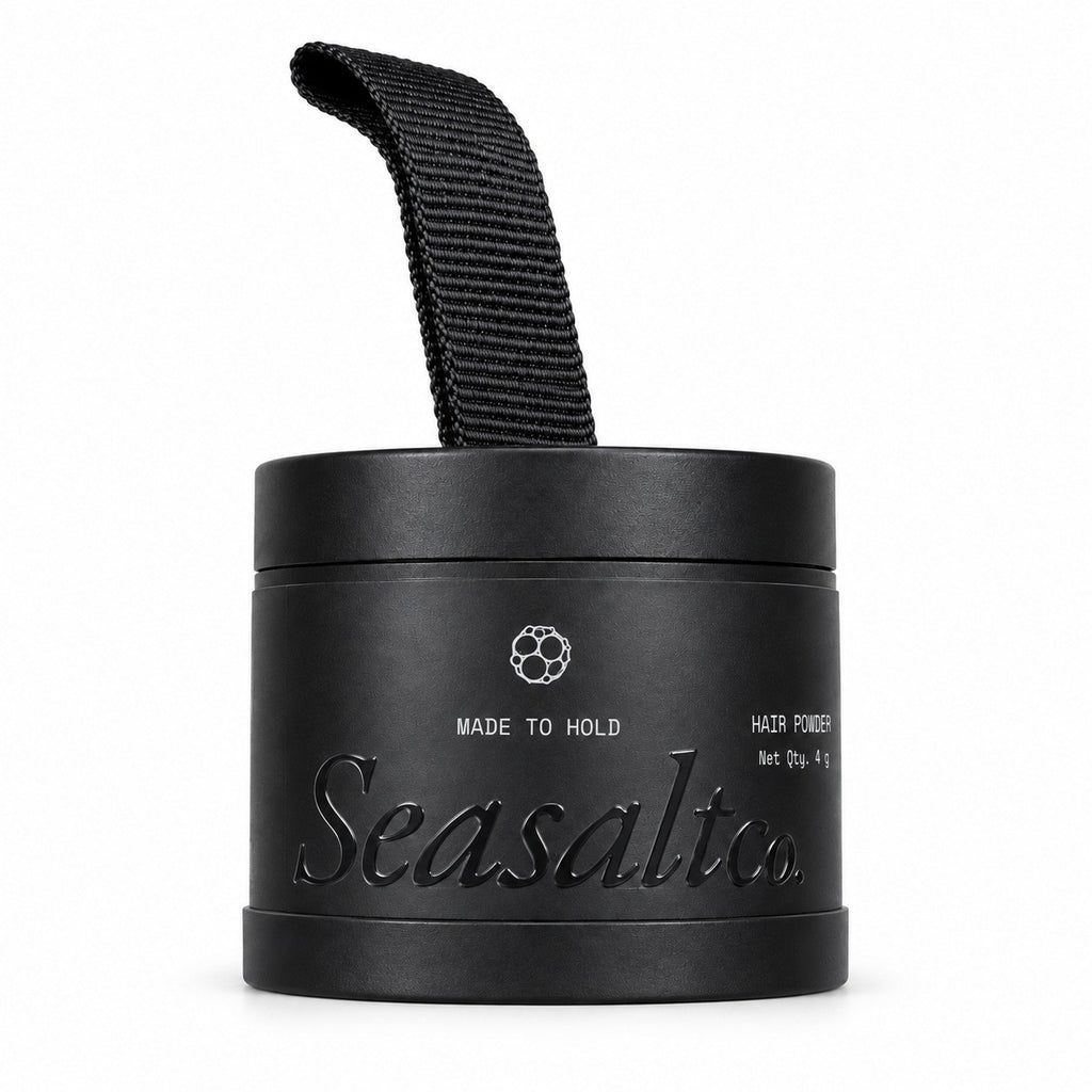 Seasaltco black hair powder container with a fabric loop, designed for filling in thinning hair and hairlines.
